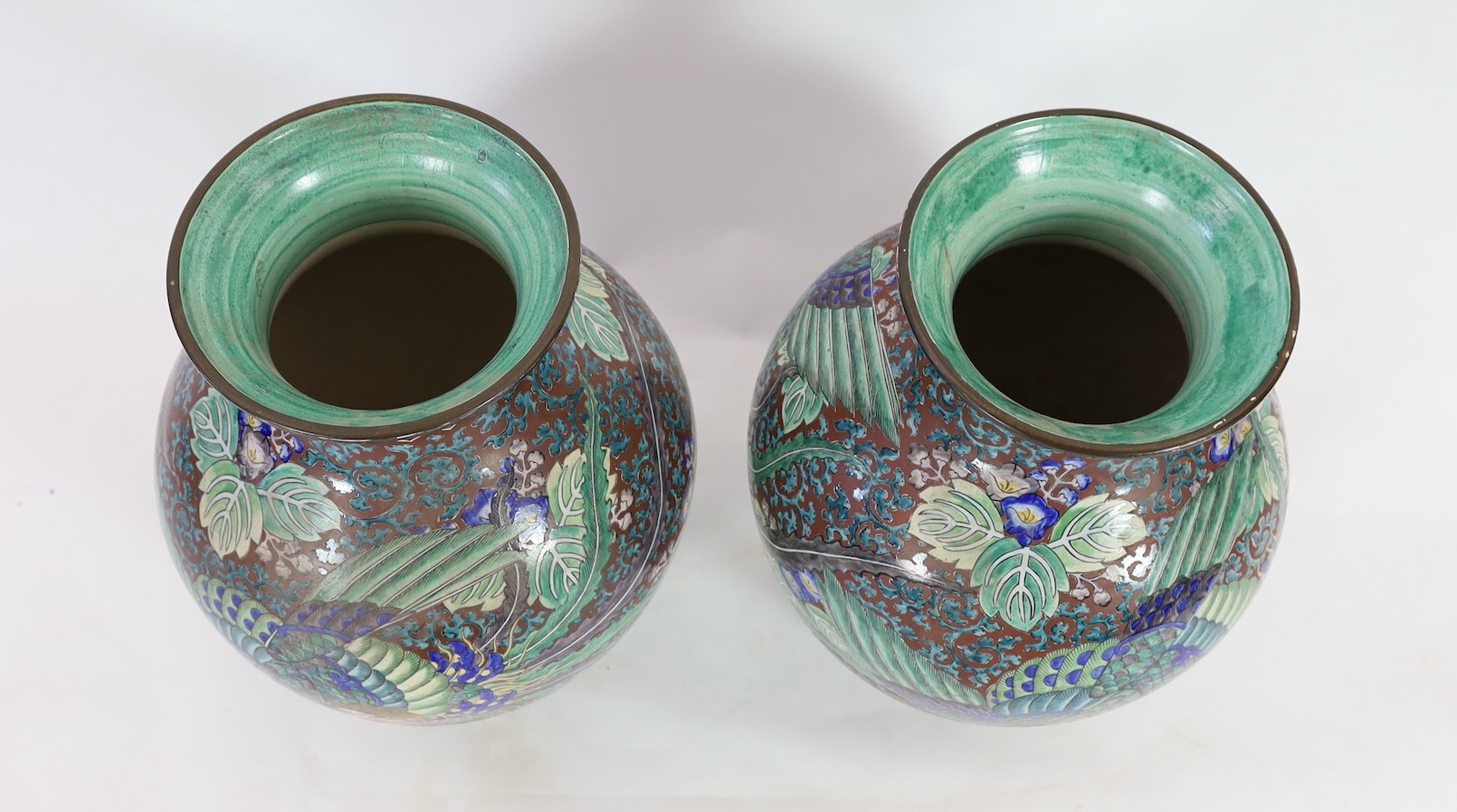 A pair of massive Japanese Kutani porcelain vases, Meiji period, influenced by de Morgan designs, 61.5cm high, one repaired